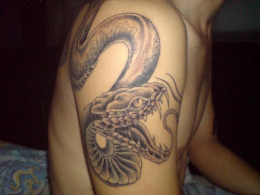 Black Ink Snake Tattoo On Man Right Upper Arm