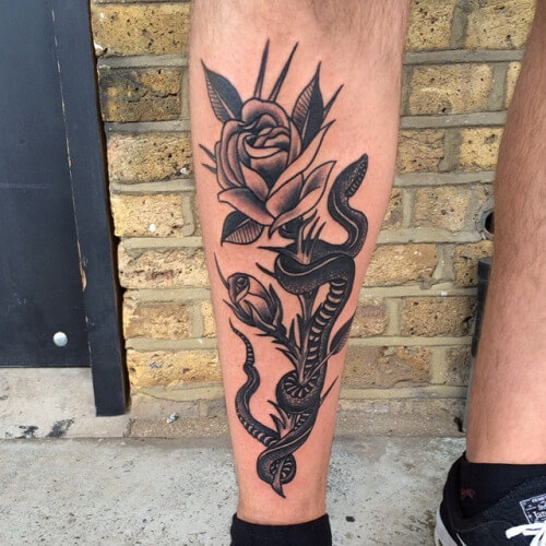 Black Ink Snake With Rose Tattoo On Left Leg