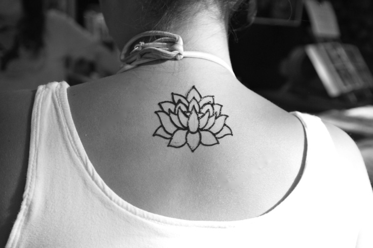 Black Outline Lotus Flowers Tattoo On Girl Back Neck