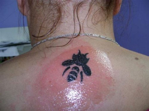 Black Tribal Bumblebee Tattoo On Women Upper Back