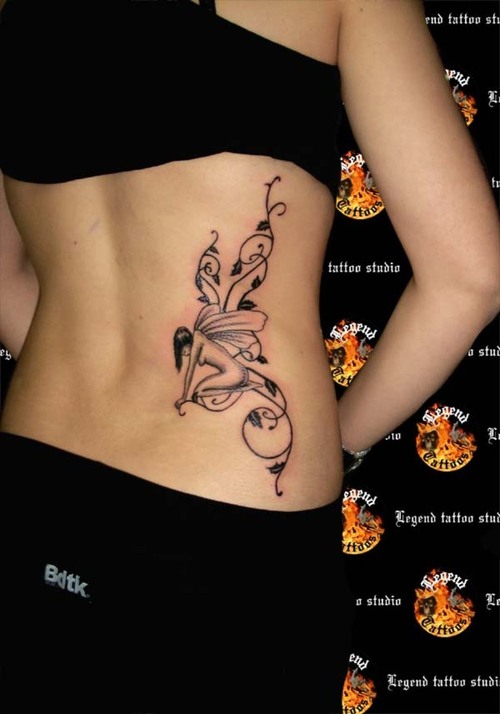 Black Tribal Fairy Tattoo On Girl Lower Back