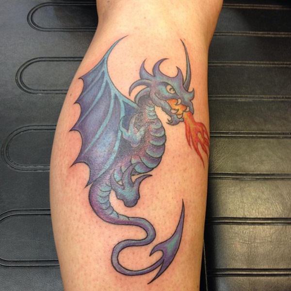 Blue Ink Flaming Dragon Tattoo On Leg