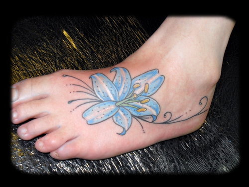 Blue Ink Lily Flower Tattoo On Left Foot
