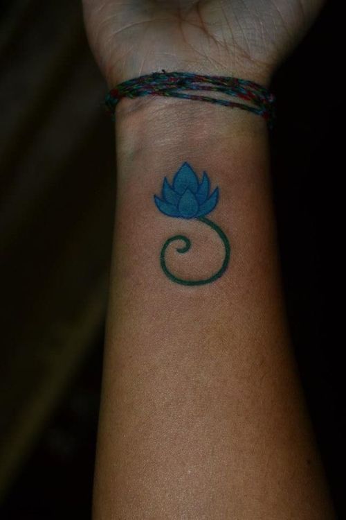 Blue Ink Lotus Flower Tattoo On Female Right Wrist