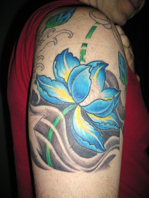 Blue Ink Lotus Flower Tattoo On Man Right Shoulder