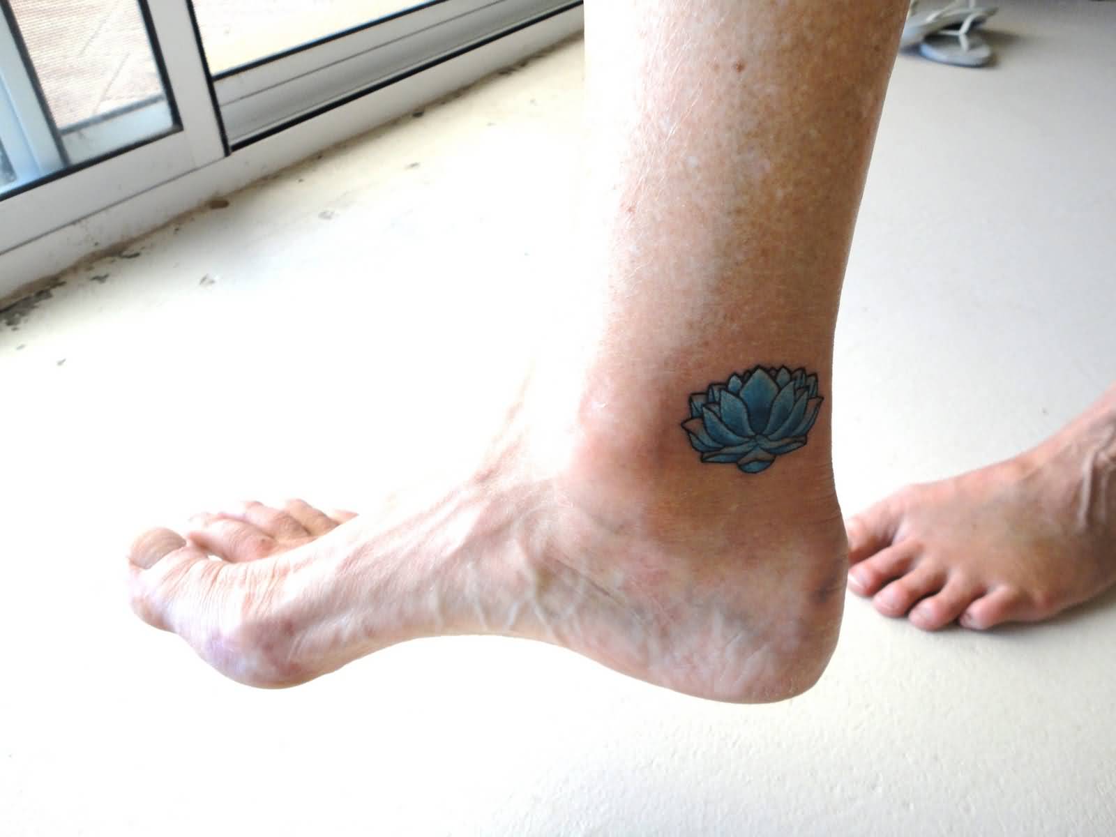 Blue Ink Lotus Flower Tattoo On Right Foot Ankle