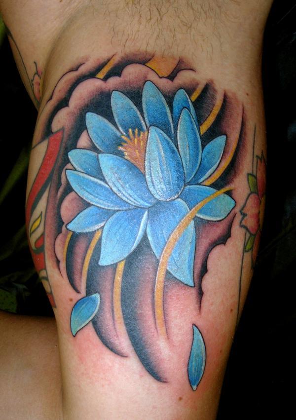 Blue Ink Lotus Tattoo On Man Bicep