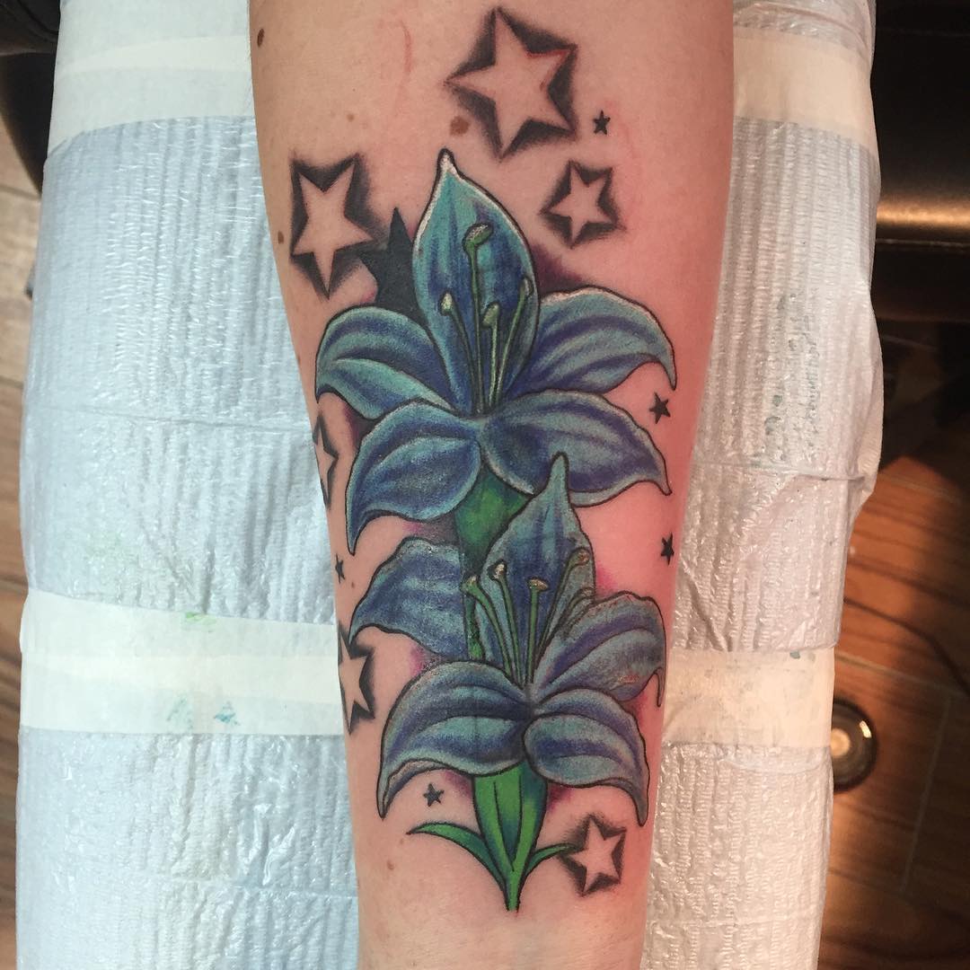 Blue Lily Flowers With Stars Tattoo On Arm