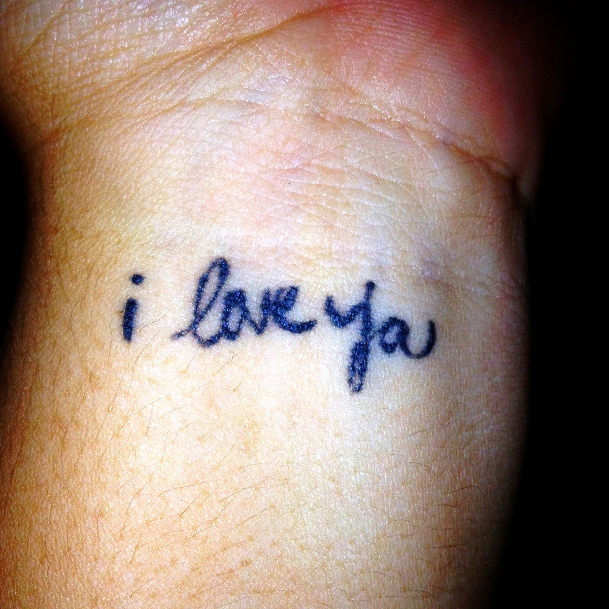 Blue ink I Love You Tattoo On Left Wrist