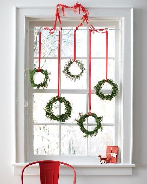 Bunch Of Evergreen Wreaths To The Curtains’s Rod With Red Ribbon Christmas Decoration
