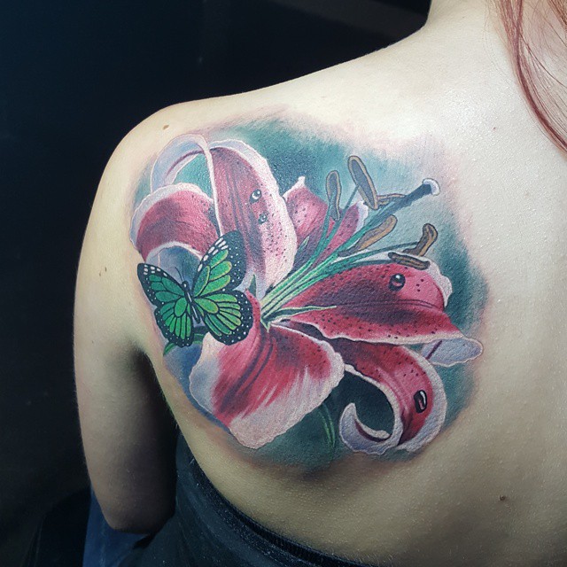 Butterfly And Stargazer Lily Tattoo On Left Back Shoulder.