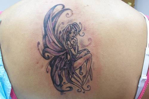 Classic Black Ink Fairy Tattoo On Girl Upper Back