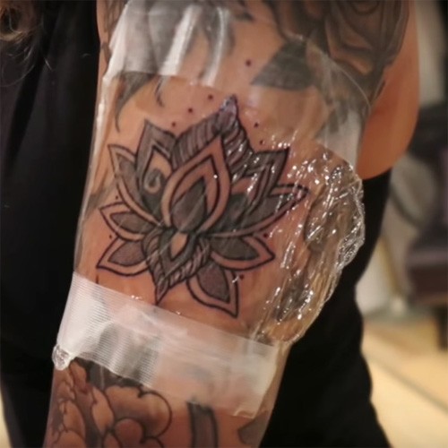 Classic Black Ink Small Lotus Flower Tattoo On Left Half Sleeve