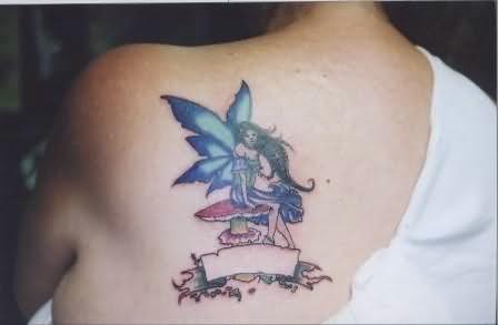 Classic Fairy On Mushroom With Ribbon Tattoo On Left Back Shoulder