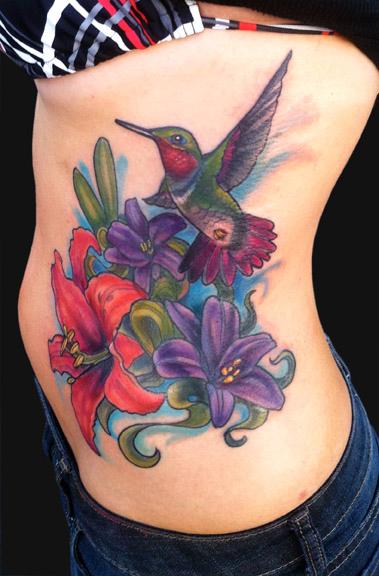 Color Hummingbird And Lily Flowers Tattoo On Side Rib