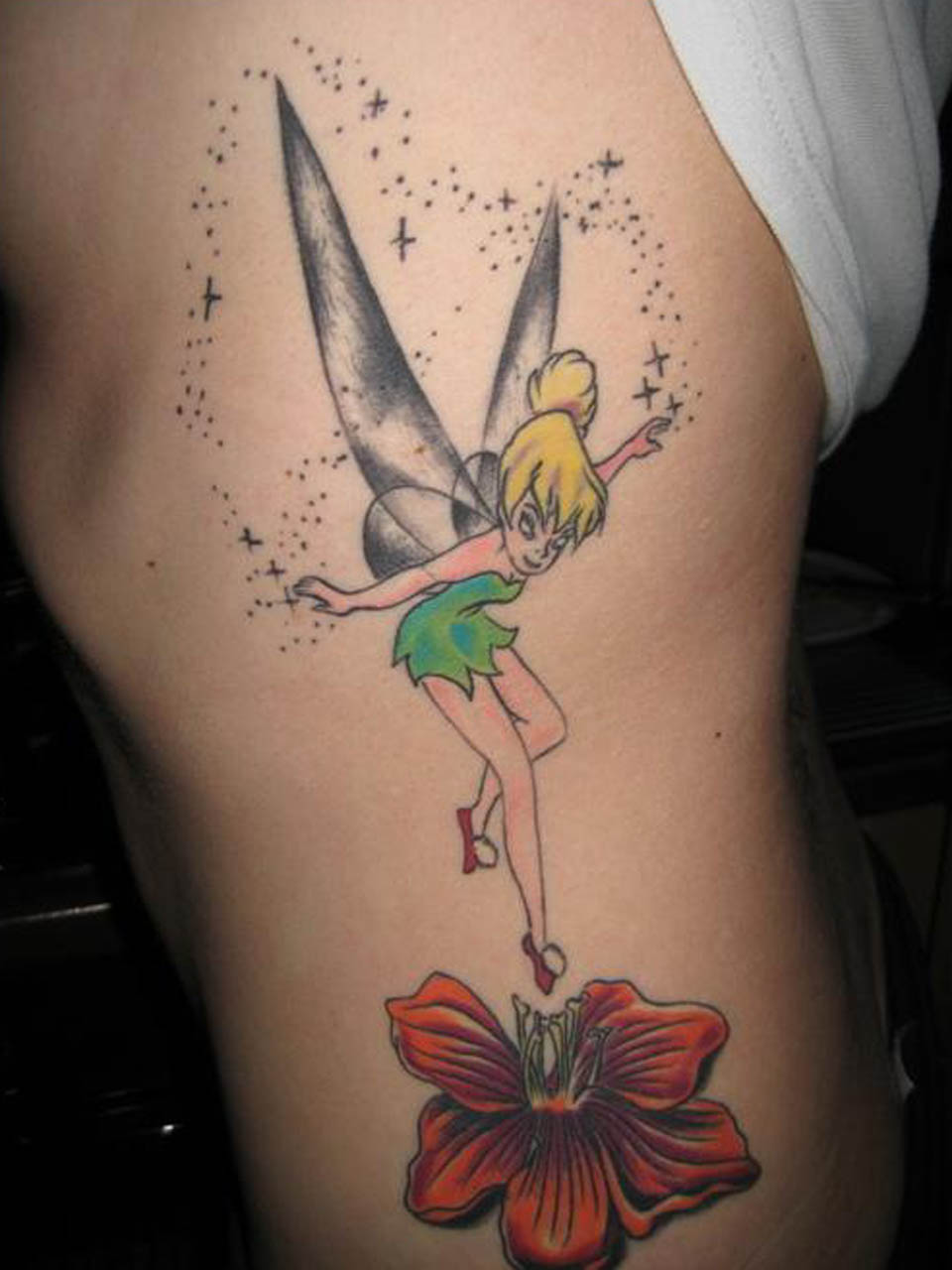 Colorful Fairy With Fairy Dust And Flower Tattoo Design For Side Rib
