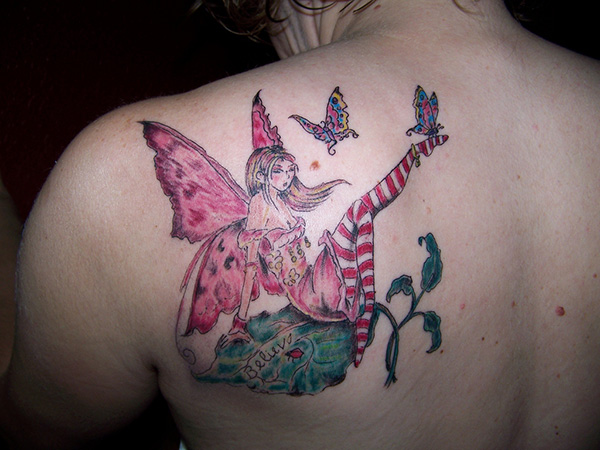 Colorful Fairy With Fairy Dust And Flying Butterflies Tattoo On Left Back Shoulder