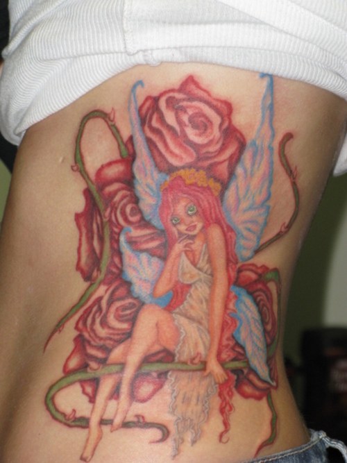 Colorful Fairy With Flowers Tattoo On Girl Left Side Rib