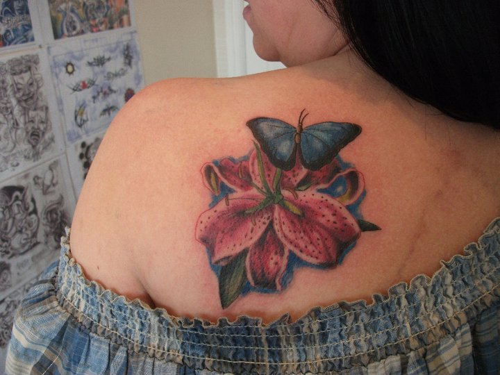 Colorful Lily Flower With Butterfly Tattoo On Left Back Shoulder