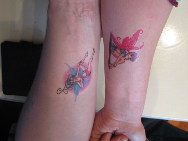 Colorful Small Fairy Tattoo On Couple Forearm