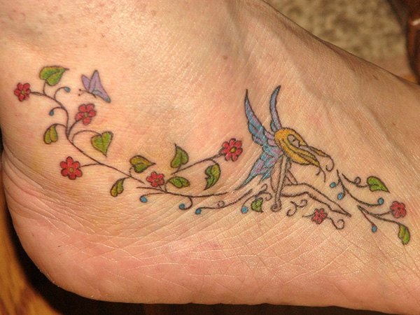 Colorful Small Fairy With Flowers Tattoo On Right Foot