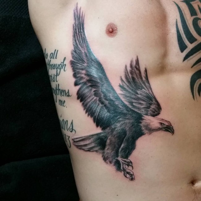 Cool Black Ink Flying Eagle Tattoo On Man Right Side Rib