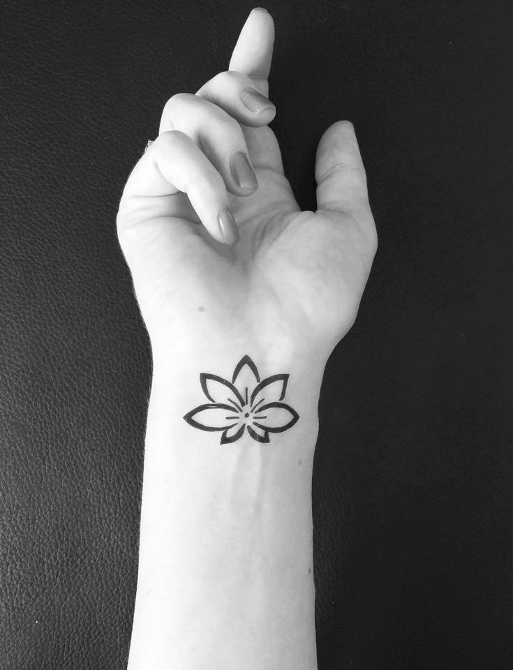 Cool Black Outline Lotus Tattoo On Girl Left Wrist