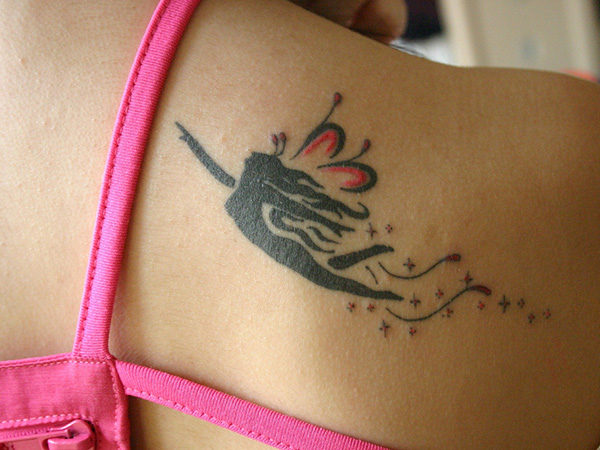 Cool Black Tribal Fairy With Fairy Dust Tattoo On Right Back Shoulder