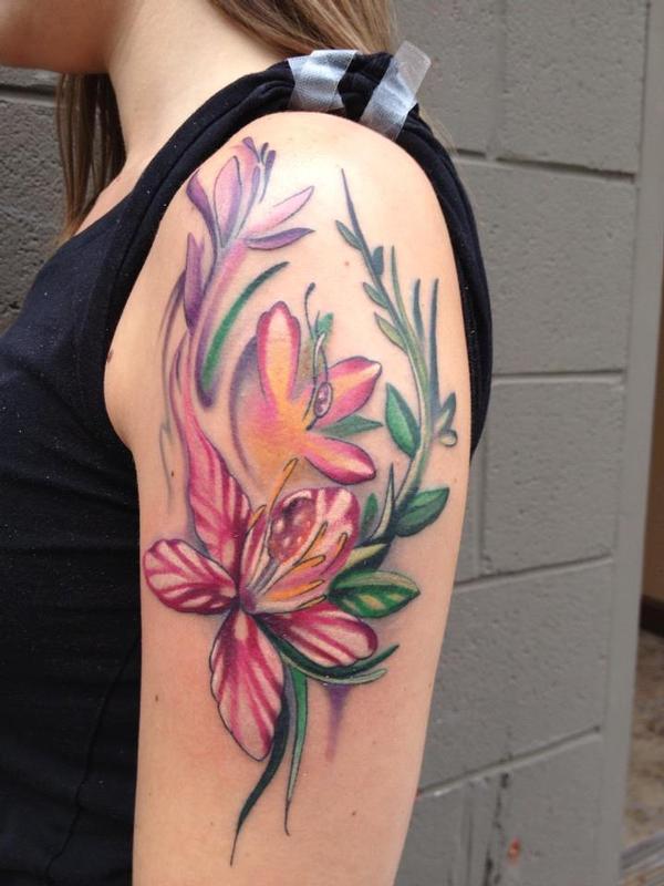 Cool Colorful Lily Flowers Tattoo On Girl Left Upper Arm