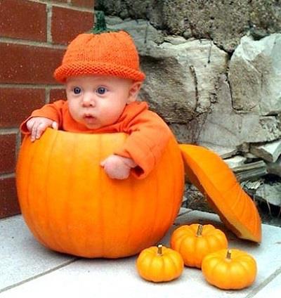 Cute Baby Sitting In Pumpkin Picture