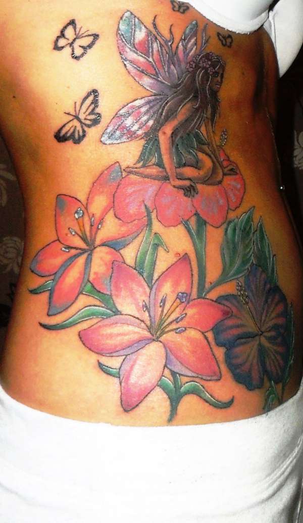 Fairy On Flowers With Flying Butterflies Tattoo On Girl Right Side Rib