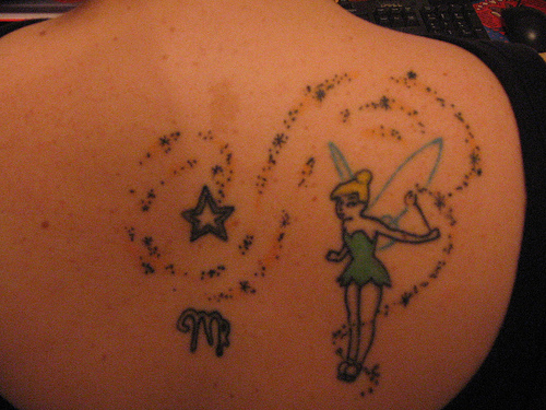 Fairy With Fairy Dust And Star Tattoo On Upper Back
