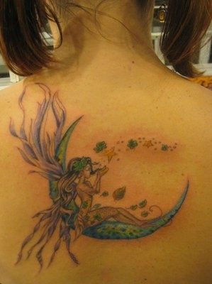 Fairy With Fairy Dust On Half Moon Tattoo On Girl Upper Back