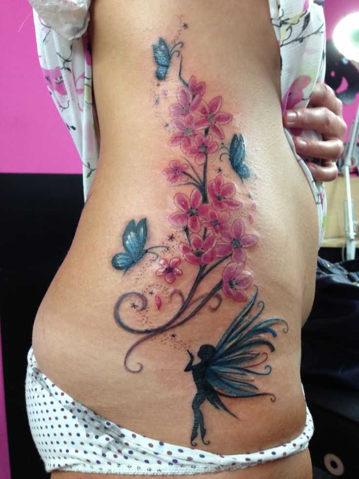 Fairy With Flowers And Flying Butterflies Tattoo On Girl Right Side Rib