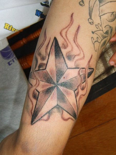 Flaming Nautical Star Tattoo On Arm
