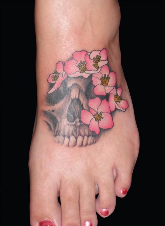 Flowers And Cherry Skull Tattoo On Left Foot