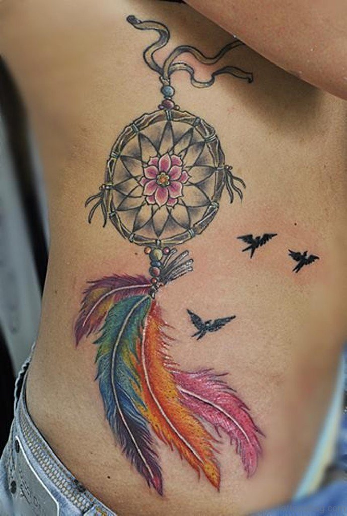 Flying Black Birds And Colorful Dreamcatcher Tattoo On Side Rib