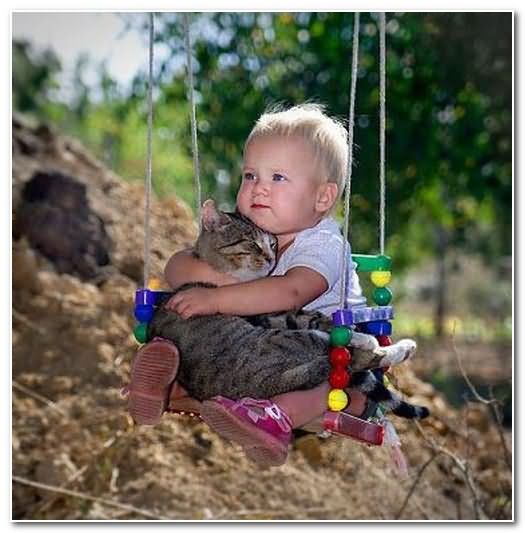 Funny Kid Swinging With Cat