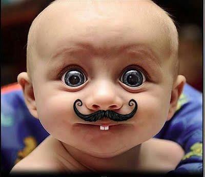 Funny Kid With Big Eyes And Mustaches