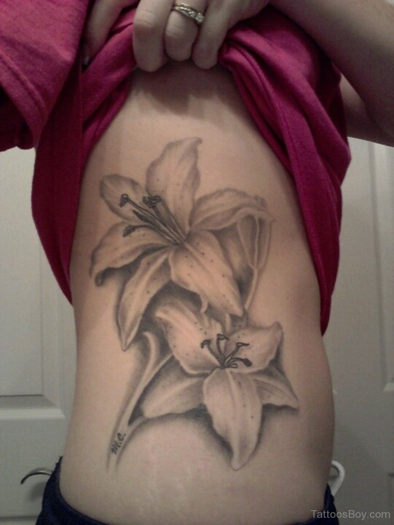 Girl Showing Her Side Rib Black And Grey Lily Tattoo