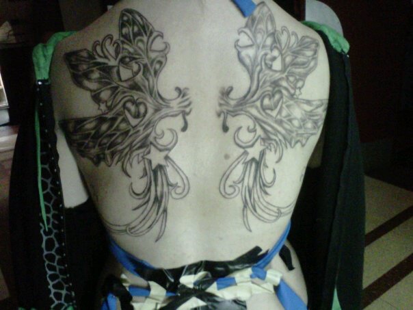 Grey Ink Fairy Wings Tattoo On Girl Upper Back