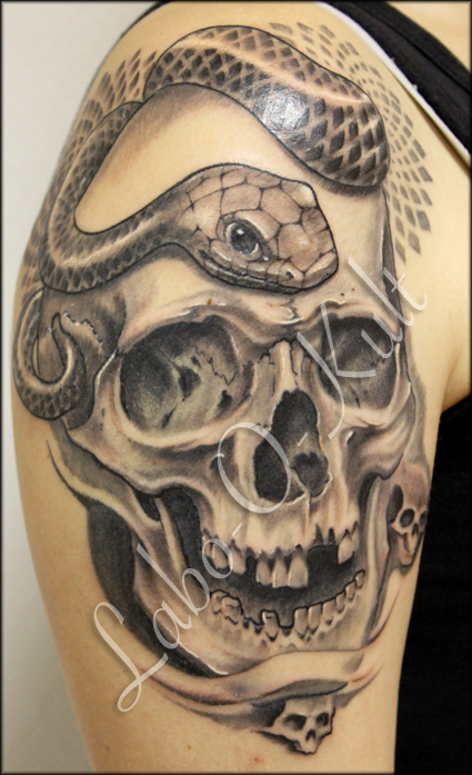 Grey Ink Skull With Snake Tattoo On Right Shoulder