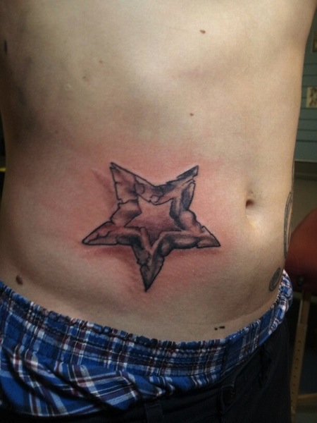 Grey Ink Star Tattoo On Stomach