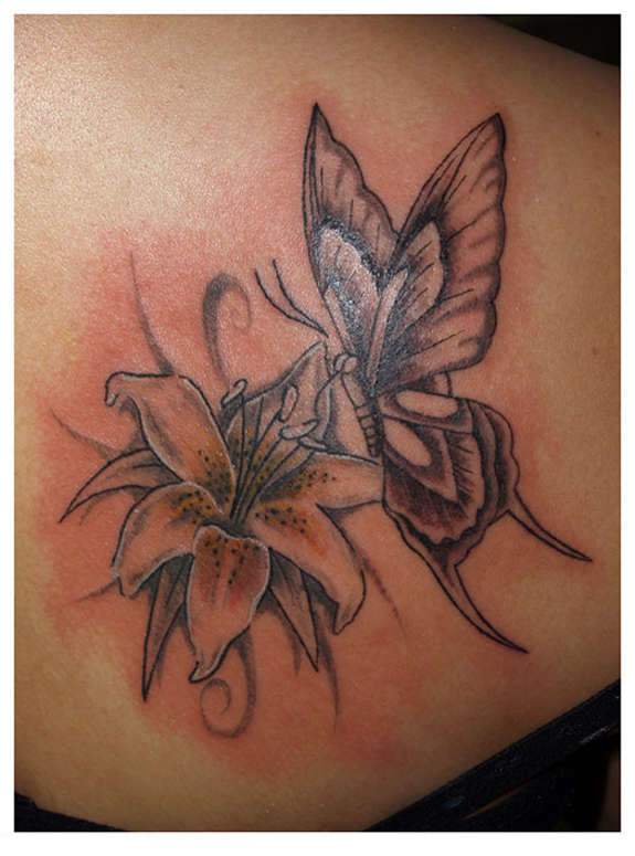Grey Lily Flower And Butterfly Tattoo On Back