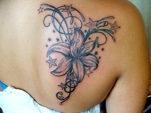 Grey Stars And Lily Tattoo On Right Back Shoulder