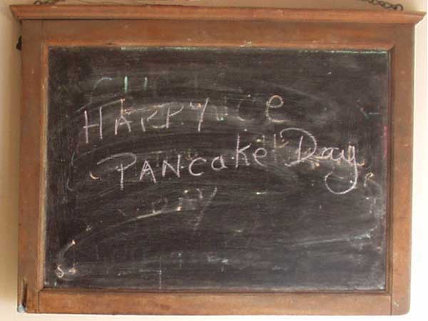 Happy Pancake Day Wishes Written On Black Board