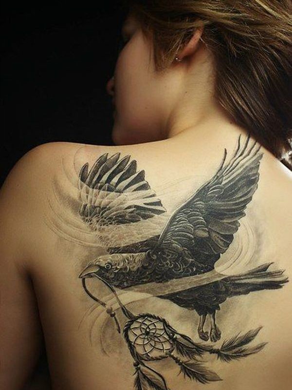 Left Back Shoulder Flying Crow With Dreamcatcher Tattoo