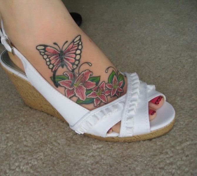 Lily Flowers With Butterfly Tattoo On Girl Right Foot