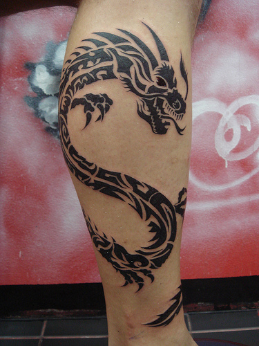 Nice Black Tribal Dragon Tattoo On Leg