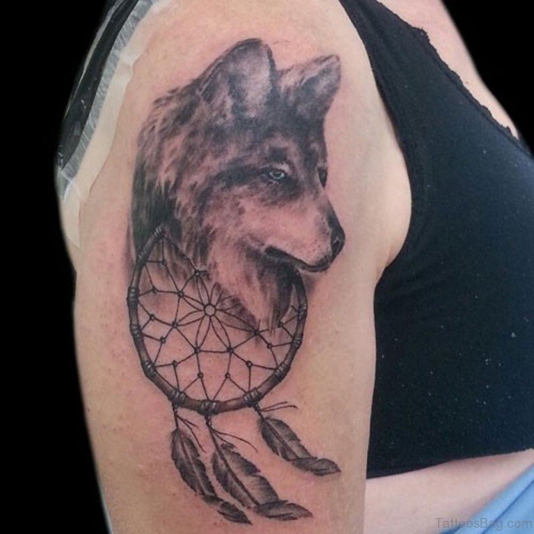 Nice Grey Ink Wolf Head And Dreamcatcher Tattoo On Right Bicep